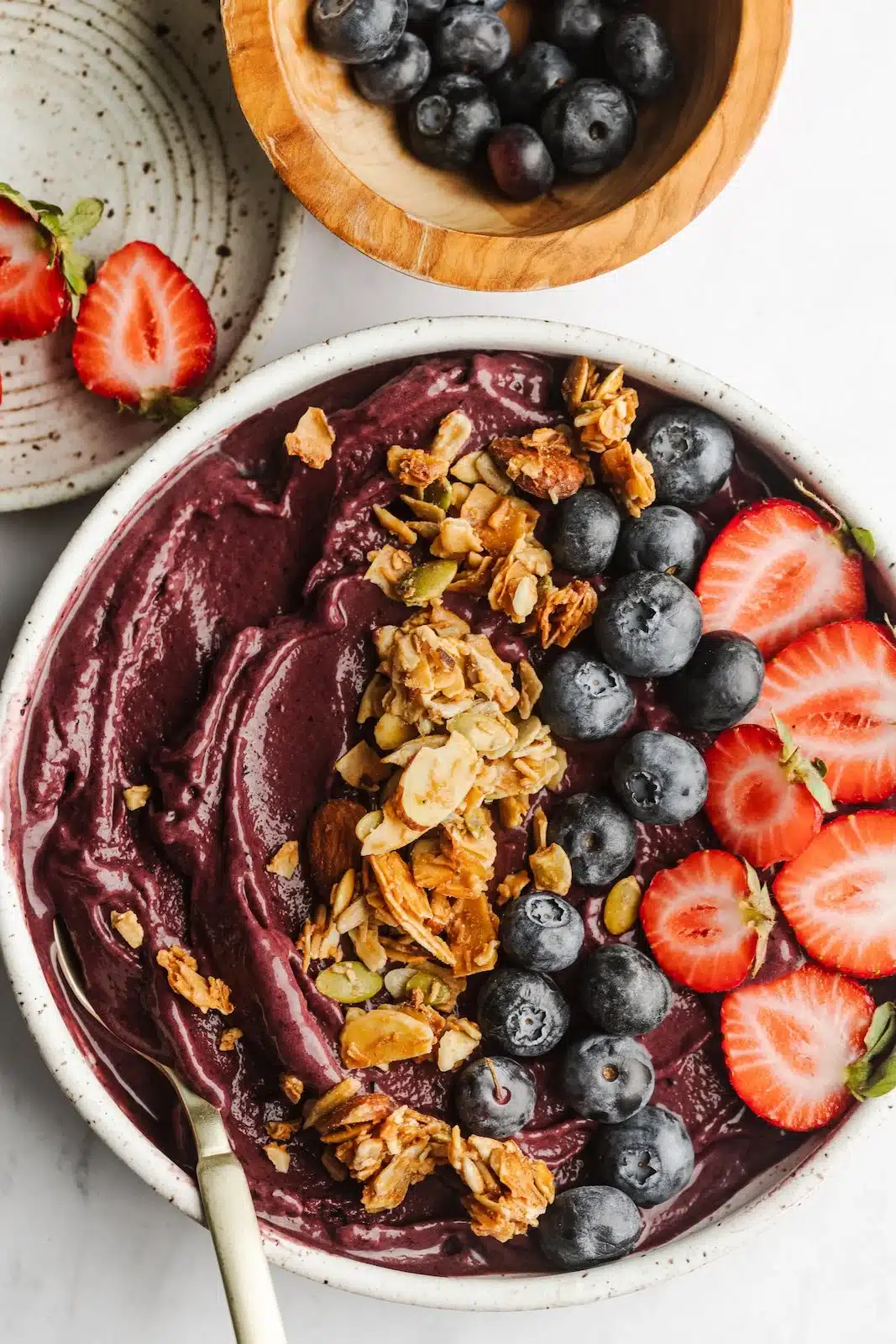 Colorful acai bowl topped with fruits and granola