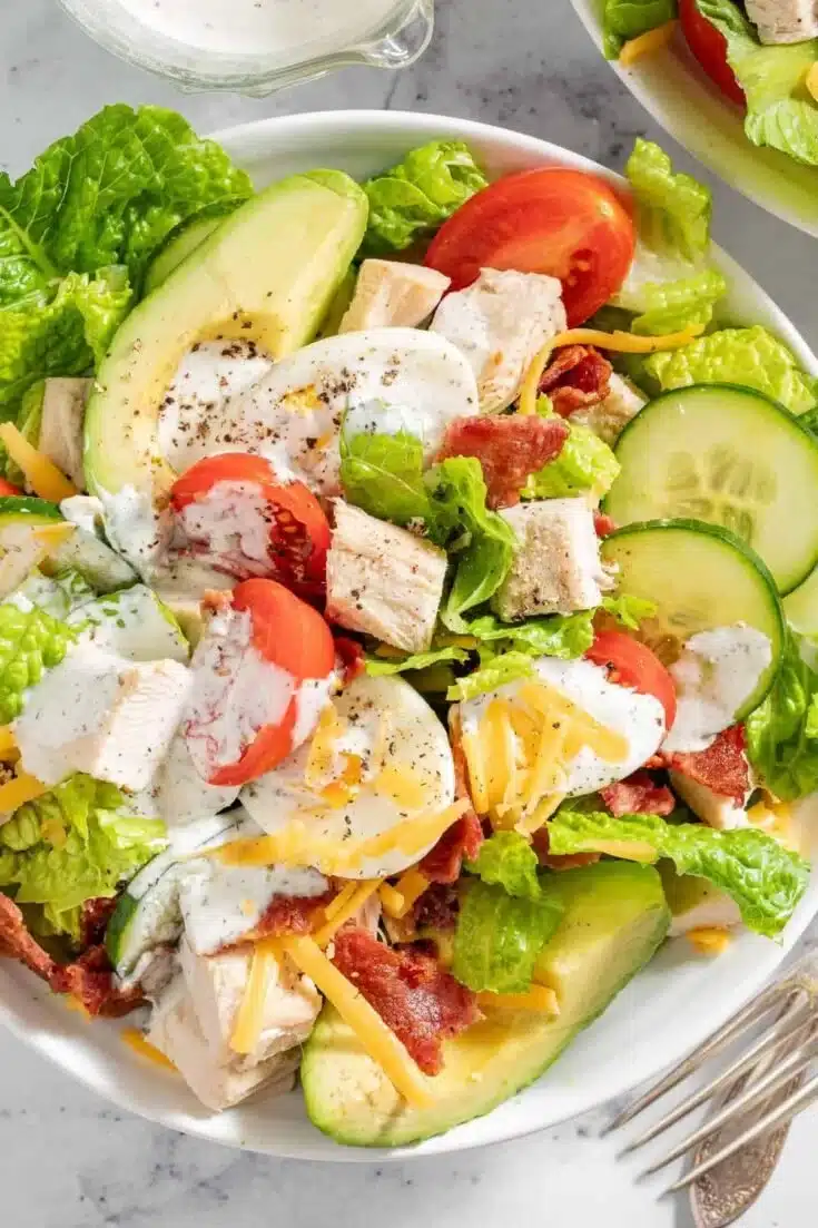 Healthy Turkey Cobb Salad with greens, turkey, hard-boiled eggs, and fresh toppings.